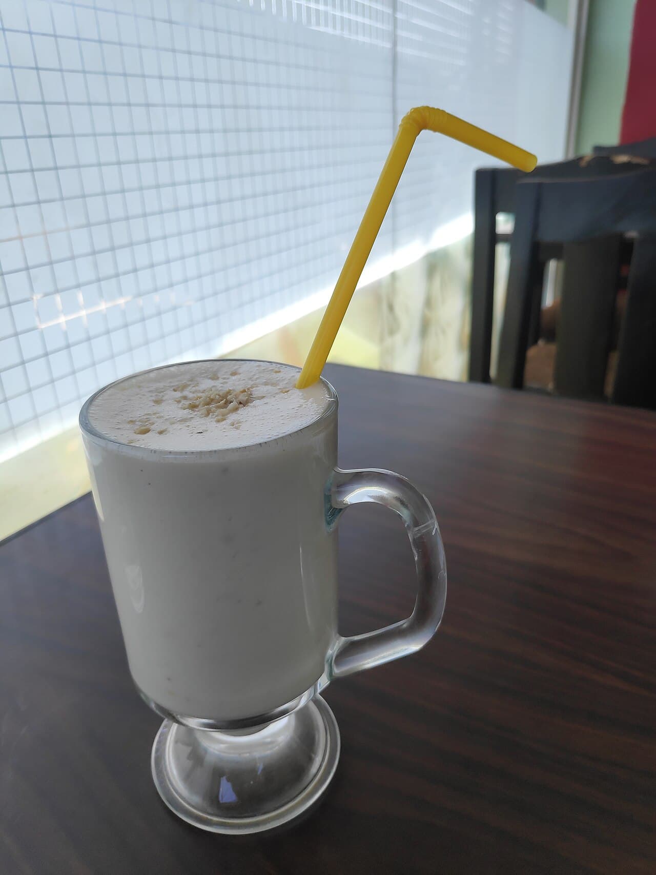 Sweet lassi served chilled in a tall glass